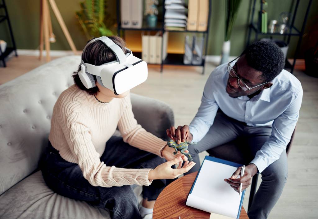 Therapist,Giving,Toy,Frog,To,Young,Patient,Wearing,Virtual,Reality Therapist,Giving,Toy,Frog,To,Young,Patient,Wearing,Virtual,Reality