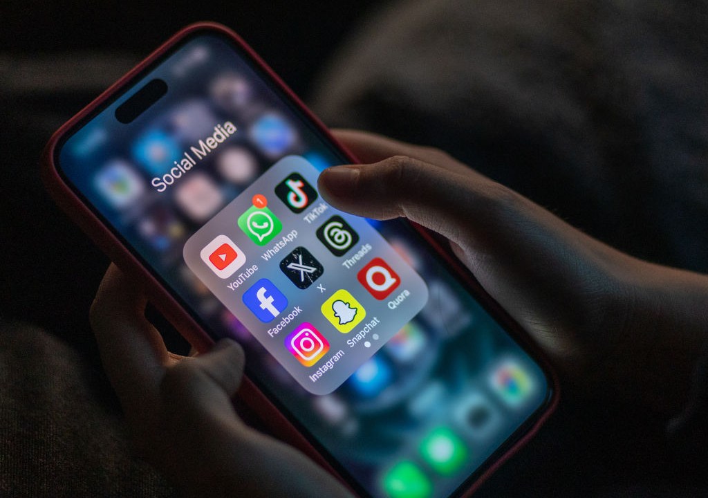 BATH, UNITED KINGDOM - DECEMBER 19: A 12-year-old boy looks at an iPhone screen showing various social media apps including TikTok, Facebook and X, on December 19, 2023 in Bath, England. The amount of time children spend on screens each day rocketed during the Covid pandemic by more than 50 per cent, the equivalent of an extra hour and twenty minutes. Researchers say that unmoderated screen time can have long-lasting effects on a child's mental and physical health. Recently TikTok announced that every account belonging to a user below age 18 have a 60-minute daily screen time limit automatically set. (Photo by Matt Cardy/Getty Images)