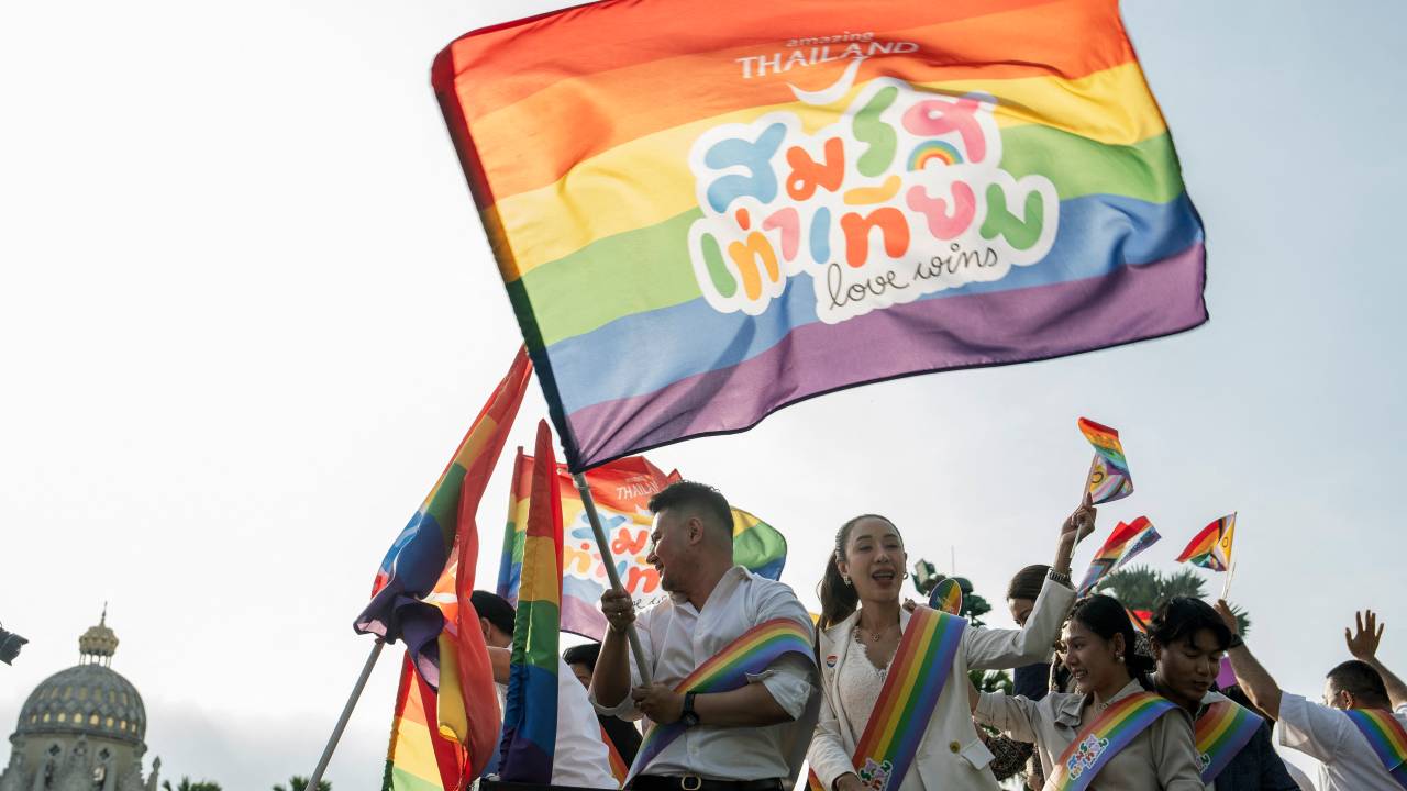 Members of the LGBTQ community celebrate after the Thai parliament passed the final senatorial vote on the same-sex marriage bill, at Government House in Bangkok on June 18, 2024. Thailand on June 18 became the first country in Southeast Asia to legalise same-sex marriage, in a historic parliamentary vote hailed as a "victory" by campaigners. (Photo by Chanakarn Laosarakham / AFP)