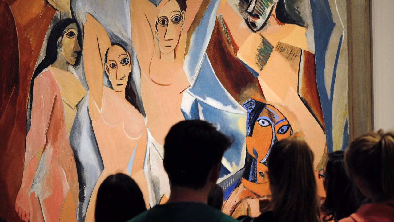NEW YORK, NY - APRIL 26, 2015: Museum of Modern Art (MoMA) visitors look at a painting by Pablo PIcasso titled 'Les Demoiselles d' Avignon,' painted by PIcasso in 1907, on display at the museum in Midtown Manhattan in New York City. (Photo by Robert Alexander/Getty Images)