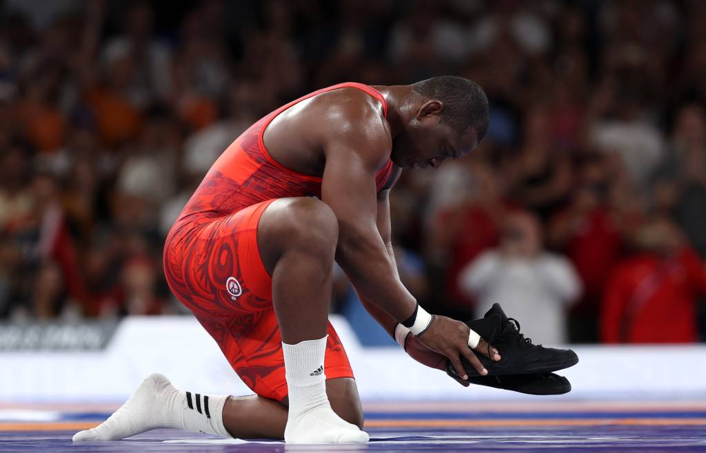 Wrestling – Olympic Games Paris 2024: Day 11 PARIS, FRANCE - AUGUST 06: Mijain Lopez Nunez of Team Cuba removes his shoes to signify his retirement following his victory and earning of fifth Olympic Gold during the Wrestling Men's Greco-roman 130kg Gold Medal match against Yasmani Acosta Fernandez of Team Chile (not pictured) on day eleven of the Olympic Games Paris 2024 at Champs-de-Mars Arena on August 06, 2024 in Paris, France. (Photo by Sarah Stier/Getty Images)