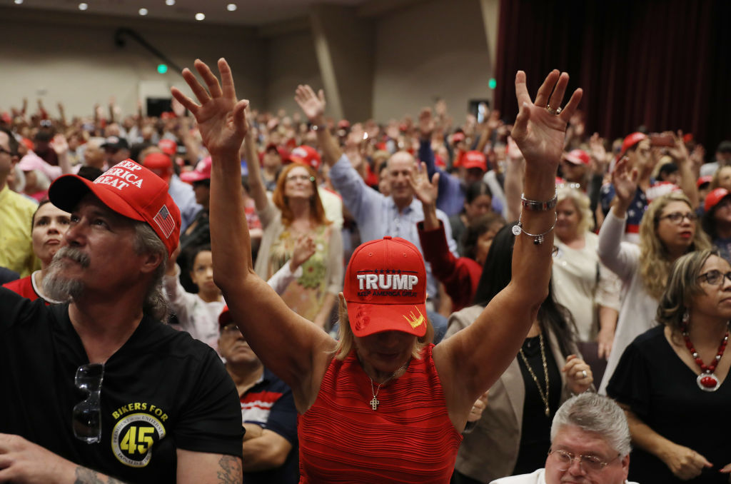 MIAMI, FLORIDA - JANUARY 03: Fran Flynn (C) prays during the 'Evangelicals for Trump' campaign event held at the King Jesus International Ministry as they await the arrival of President Donald Trump on January 03, 2020 in Miami, Florida. The rally was announced after a December editorial published in Christianity Today called for the President Trump's removal from office. (Photo by Joe Raedle/Getty Images)