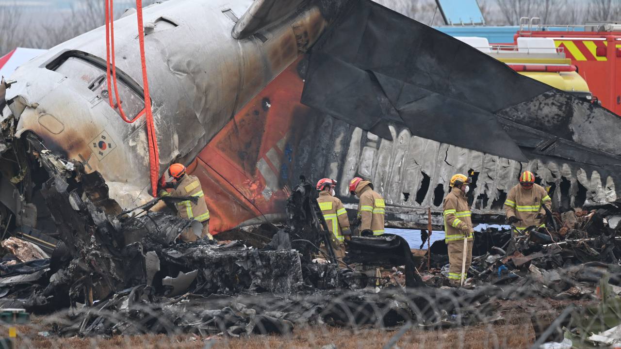 Firefighters and recovery teams work at the scene where a Jeju Air Boeing 737-800 series aircraft crashed and burst into flames at Muan International Airport in Muan, some 288 kilometres southwest of Seoul on December 30, 2024. The Boeing 737-800 was carrying 181 people from Thailand to South Korea when it crashed on arrival on December 29, killing everyone aboard -- save two flight attendants pulled from the twisted wreckage of the worst aviation disaster on South Korean soil. (Photo by JUNG YEON-JE / AFP)