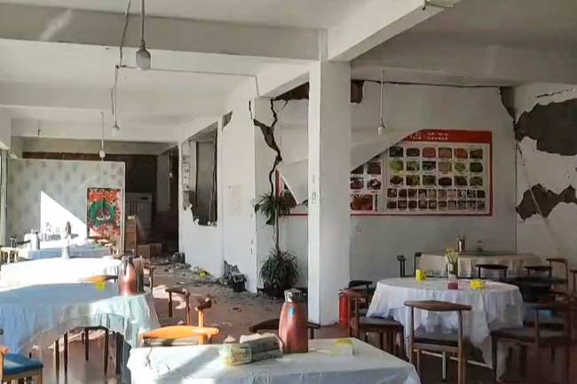 This frame grab from a user-generated content (UGC) video on January 7, 2025 shows cracks on the walls of a restaurant in Lhatse County in China's Tibet after an earthquake struck the area. A devastating earthquake in China's remote Tibet region killed at least 53 people and collapsed 
