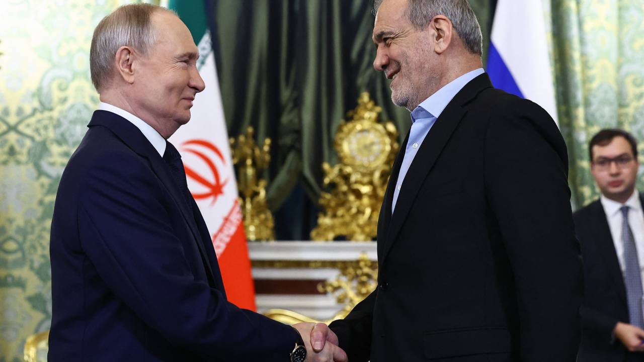 Russian President Vladimir Putin and Iranian President Masoud Pezeshkian shake hands during a meeting at the Kremlin in Moscow on January 17, 2025. (Photo by Evgenia Novozhenina / POOL / AFP)