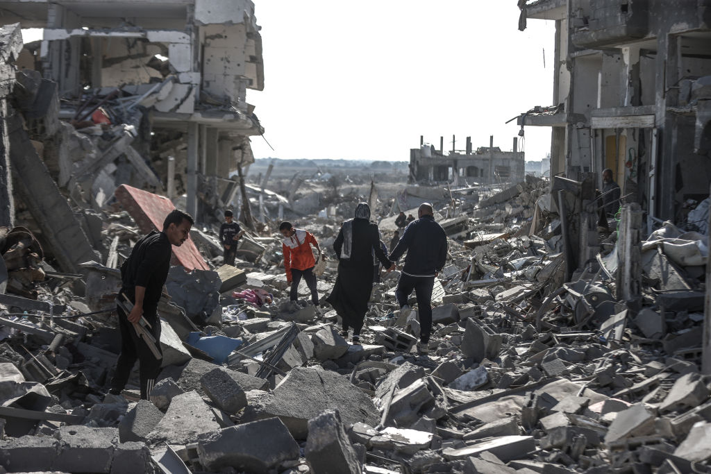 DEIR AL BALAH, GAZA - JANUARY 20: Displaced Palestinians continue to return their houses past heavily damaged and partially collapsed buildings after the ceasefire and hostage-prisoner swap deal between Hamas and Israel at Bureij refugee camp in Deir al-Balah, Gaza on January 20, 2025. (Photo by Ali Jadallah/Anadolu via Getty Images)
