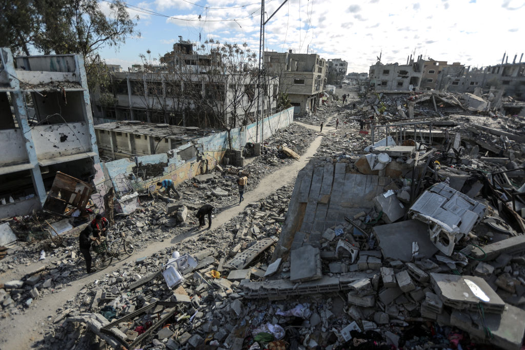 DEIR AL BALAH, GAZA - JANUARY 20: A general view of the heavily damaged and partially collapsed buildings as displaced Palestinians continue to return their houses after the ceasefire and hostage-prisoner swap deal between Hamas and Israel at Bureij refugee camp in Deir al-Balah, Gaza on January 20, 2025. (Photo by Ali Jadallah/Anadolu via Getty Images)