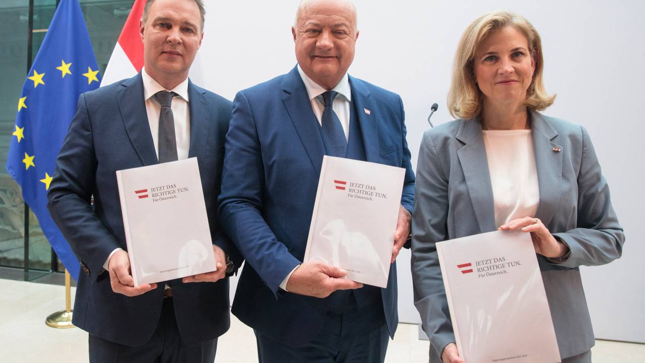 (L-R): Chairman of the Social Democratic Party of Austria (SPOe) Andreas Babler, Chairman of the Austrian People's Party (OeVP) Christian Stocker and Chairwoman of the liberal NEOS Beate Meinl-Reisinger pose with their parties' coalition program at the parliament in Vienna, Austria, on February 27, 2025. (Photo by Alex HALADA / AFP)