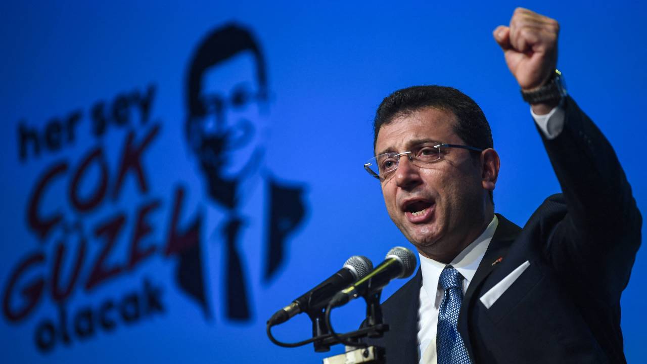 (FILES) Turkish opposition candidate for the Istanbul re-run for the mayor's election, Ekrem Imamoglu gestures as he delivers a speech on stage during his repeated political campaign coordination meeting on May 22, 2019 in Istanbul. Turkish police raided the home of Istanbul Mayor Ekrem Imamoglu on March 19, 2025, detaining him over a corruption probe in a move denounced by the main opposition CHP party as a "coup". (Photo by OZAN KOSE / AFP)