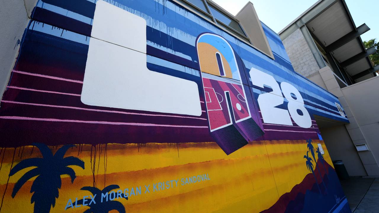 VAN NUYS, CALIFORNIA - SEPTEMBER 01: A mural reveals the new LA28 logo, with the "A" designed by Orlando Pride player Alex Morgan, at the Delano Recreation Center on September 01, 2020 in Van Nuys, California. The LA28 logo is for the Games of the XXXIV Olympiad hosted by Los Angeles in 2028. The 2028 Summer Olympics are scheduled to take place from July 21, 2028 to August 6, 2028.