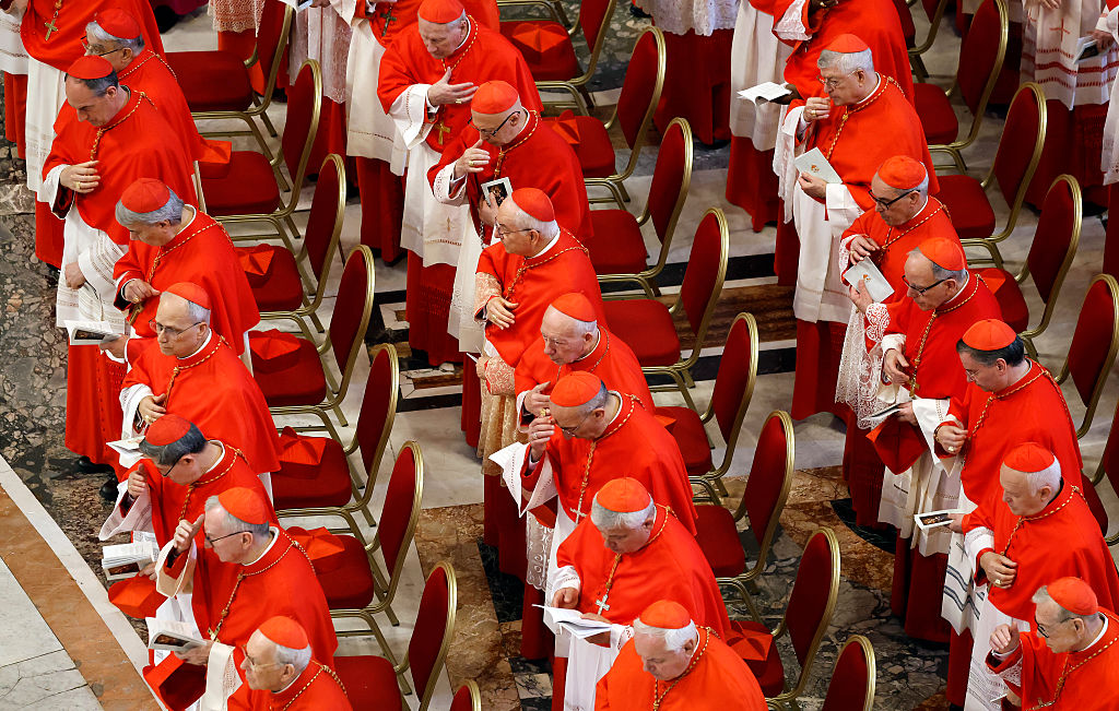 VATICAN CITY, VATICAN - APRIL 23: Cardinals look on as the body of Pope Francis is transferred into the Basilica at St Peter’s Square on April 23, 2025 in Vatican City, Vatican. On the third day since the death of Pope Francis was announced by the Vatican, his body is transferred from the Chapel of Santa Marta to the Basilica St Peter. He will lie in state in a simple wooden coffin until his funeral, which will be held on Saturday, 26th April 2025. (Pool photo by Mario Tama/Getty Images)