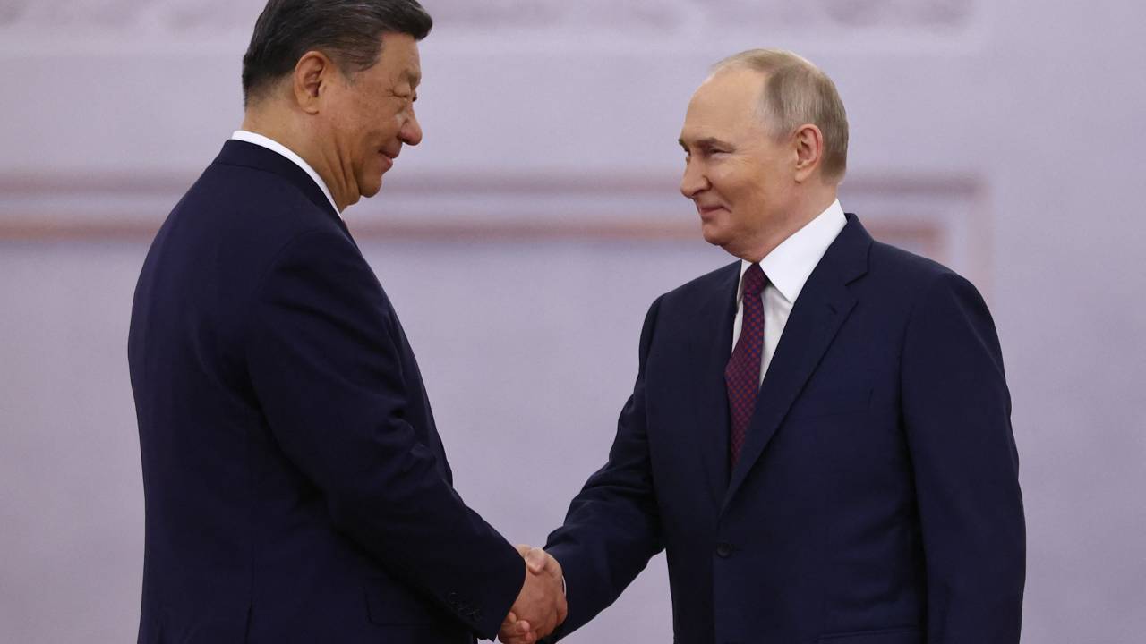 Russian President Vladimir Putin and his Chinese counterpart Xi Jinping shake hands during a welcoming ceremony before their talks at the Kremlin in Moscow on May 8, 2025. (Photo by Evgenia Novozhenina / POOL / AFP)