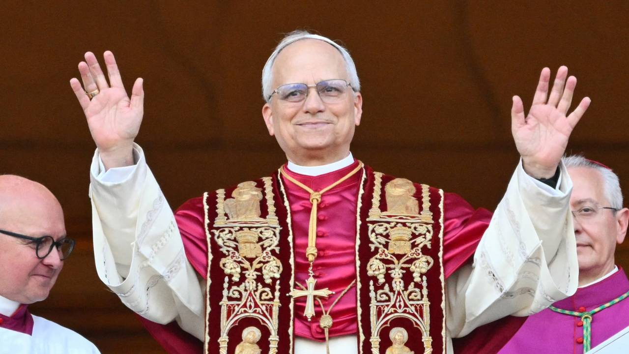 Newly elected Pope Leo XIV, Robert Prevost arrives on the main central loggia balcony of the St Peter's Basilica for the first time, after the cardinals ended the conclave, in The Vatican, on May 8, 2025. Robert Francis Prevost was on Thursday elected the first pope from the United States, the Vatican announced. A moderate who was close to Pope Francis and spent years as a missionary in Peru, he becomes the Catholic Church's 267th pontiff, taking the papal name Leo XIV. (Photo by Alberto PIZZOLI / AFP)