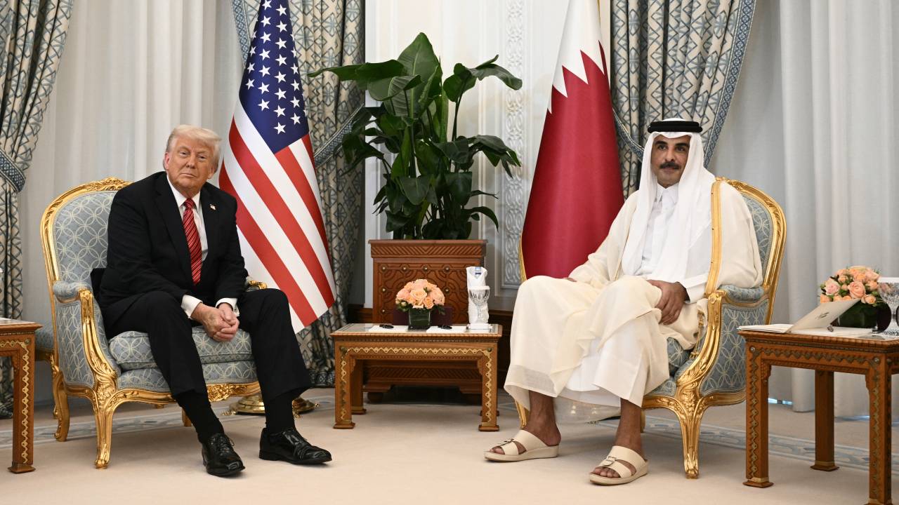 Qatar's Emir Sheikh Tamim bin Hamad al-Thani (R) meets with US President Donald Trump in the Qatari capital Doha on May 14, 2025. Trump touched down at Hamad International Airport in Doha, with relations between the two governments in the spotlight over Qatar's offer to Trump of a $400 million luxury aircraft to serve as a new Air Force One and then pass into his personal use. (Photo by Brendan SMIALOWSKI / AFP)