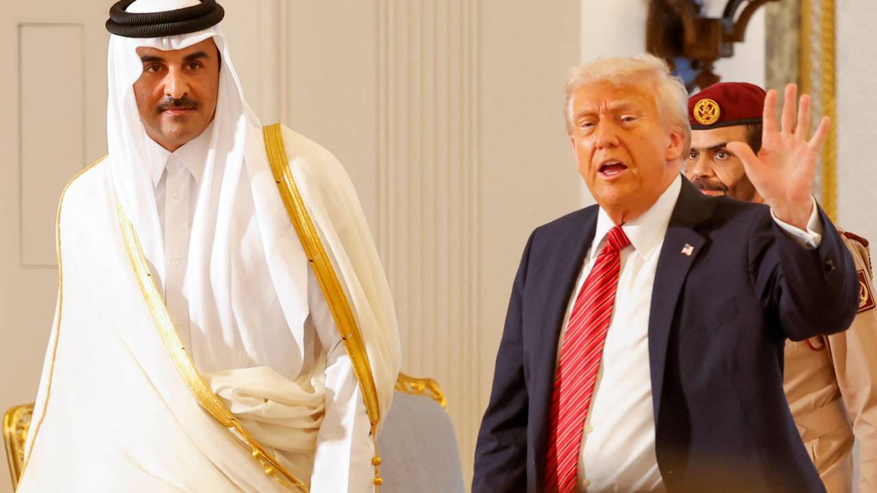 Qatar's Emir Sheikh Tamim bin Hamad al-Thani (L) and US President Donald Trump leave after a signing ceremony at the Royal Palace in Doha on May 14, 2025. (Photo by Karim JAAFAR / AFP)