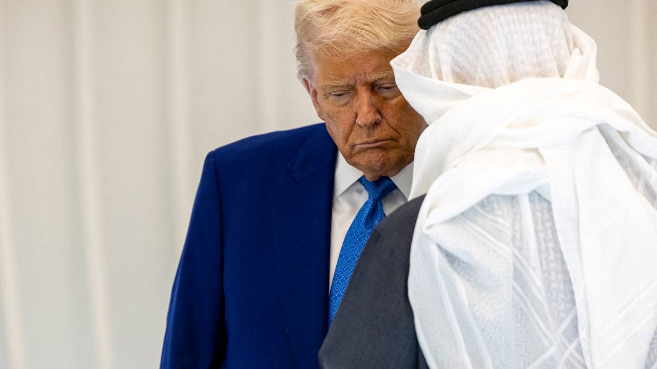 In this handout picture released by the UAE Presidential Court, US President Donald Trump listens to an Emirati official at the the UAE USA AI Cluster, during the launching ceremony in Abu Dhabi on May 15, 2025. The United Arab Emirates is the third leg of Trump's visit to the region, which has already taken him to Saudi Arabia and Qatar. (Photo by Ryan CARTER / UAE PRESIDENTIAL COURT / AFP) / RESTRICTED TO EDITORIAL USE - MANDATORY CREDIT "AFP PHOTO / UAE PRESIDENTIAL COURT / HANDOUT / " - NO MARKETING NO ADVERTISING CAMPAIGNS - DISTRIBUTED AS A SERVICE TO CLIENTS