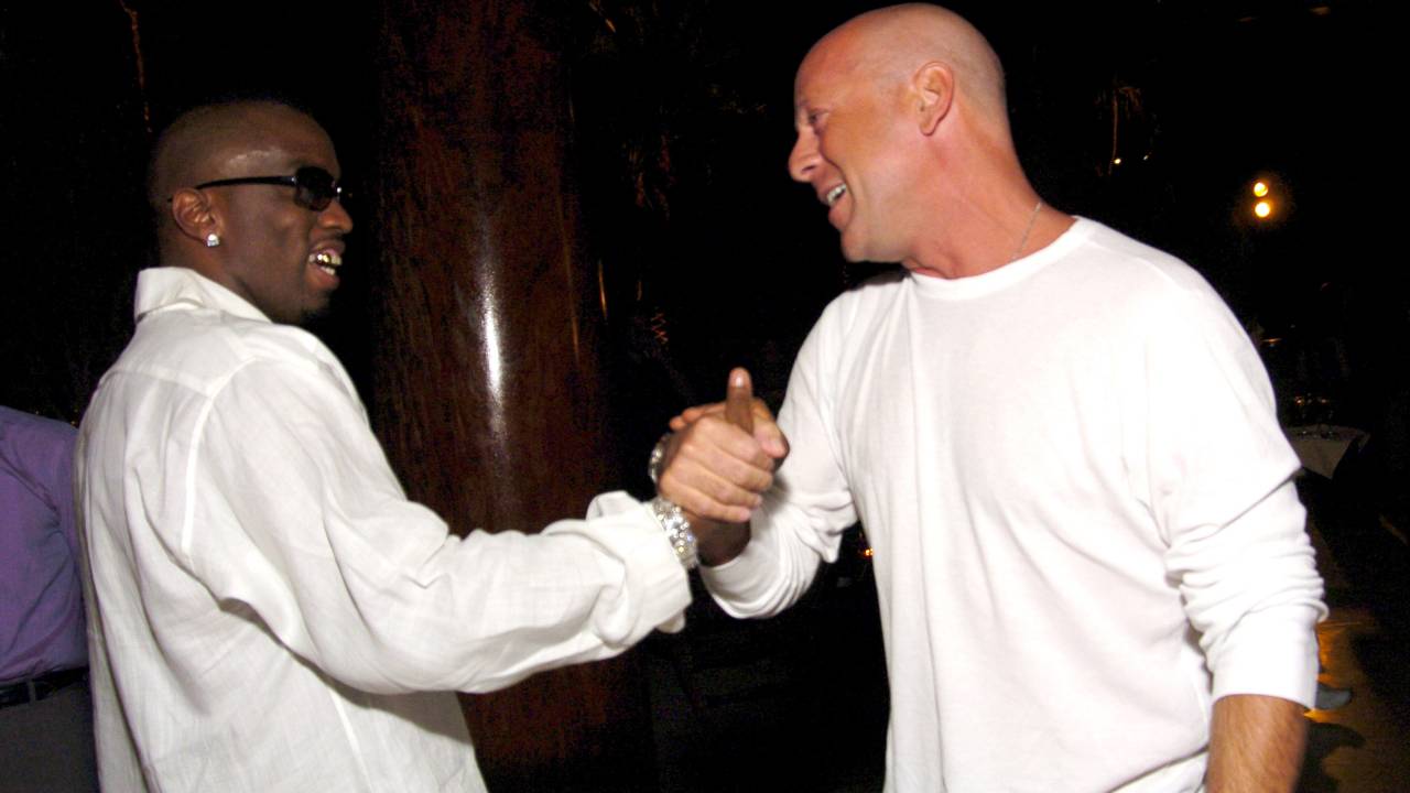 Sean P. Diddy Combs and Bruce Willis during Sean P. Diddy Comb's 50 Fabulous Dinner Party at Private Residence in Miami, Florida, United States. (Photo by KMazur/WireImage for InStyle Magazine)