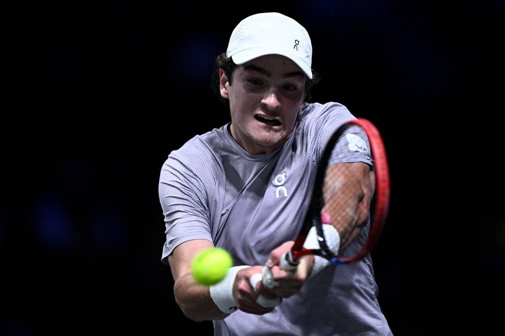 Brazil's Joao Fonseca plays a backhand return to Russia's Karen Khachanov during their men's singles match on day three of the Paris ATP Masters 1000 tennis tournament at the Paris La Défense Arena in Nanterre, on the outskirts of Paris, on October 29, 2025. (Photo by JULIEN DE ROSA / AFP)