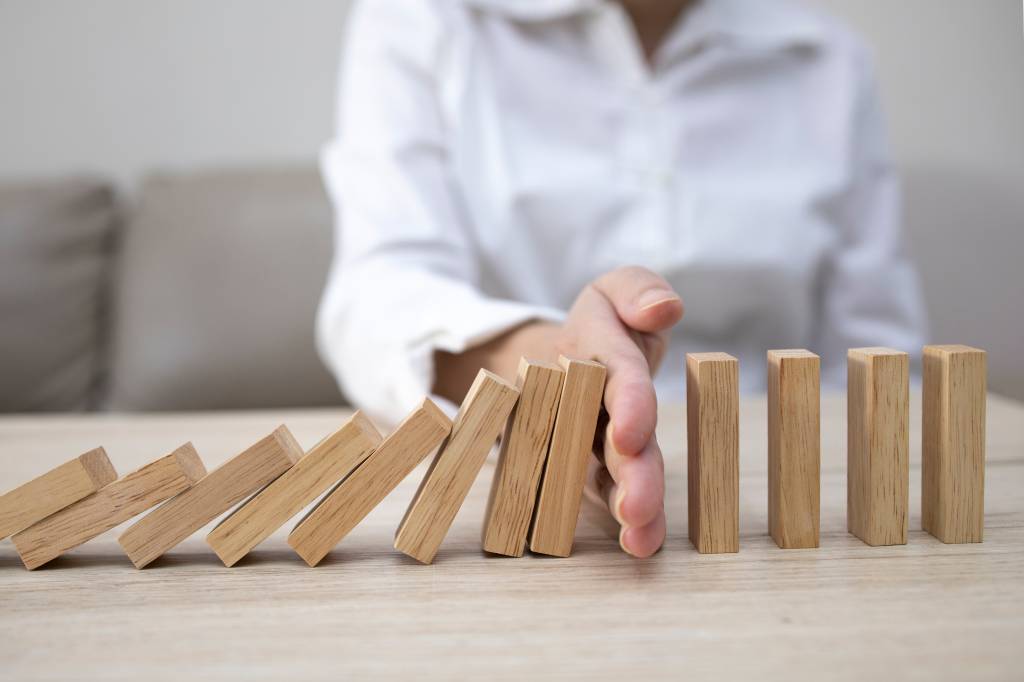 Business man placing wooden block on a tower concept risk control, Planning and strategy in business.Alternative risk concept,Risk To Make Buiness Growth Concept With Wooden Blocks