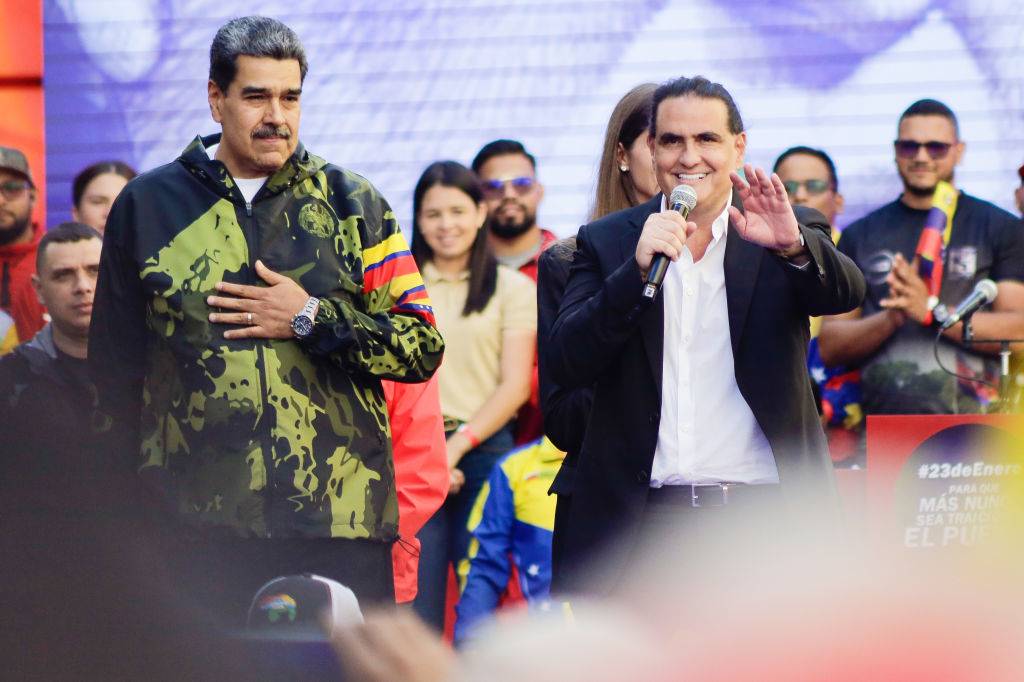 CARACAS, VENEZUELA - JANUARY 23: (L-R) President of Venezuela Nicolas Maduro gestures as President of Venezuela's International Center for Productive Investment Alex Saab speaks during a march for the 65th anniversary of the overthrow of dictator Marcos Perez Jimenez on January 23, 2024 in Caracas, Venezuela. Following the opposition presidential candidate María Corina Machado of the Vente Venezuela party's rally, the ruling Partido Socialista Unido de Venezuela party called to march and show its muscle in the streets of Caracas. (Photo by Javier Campos/Getty Images)