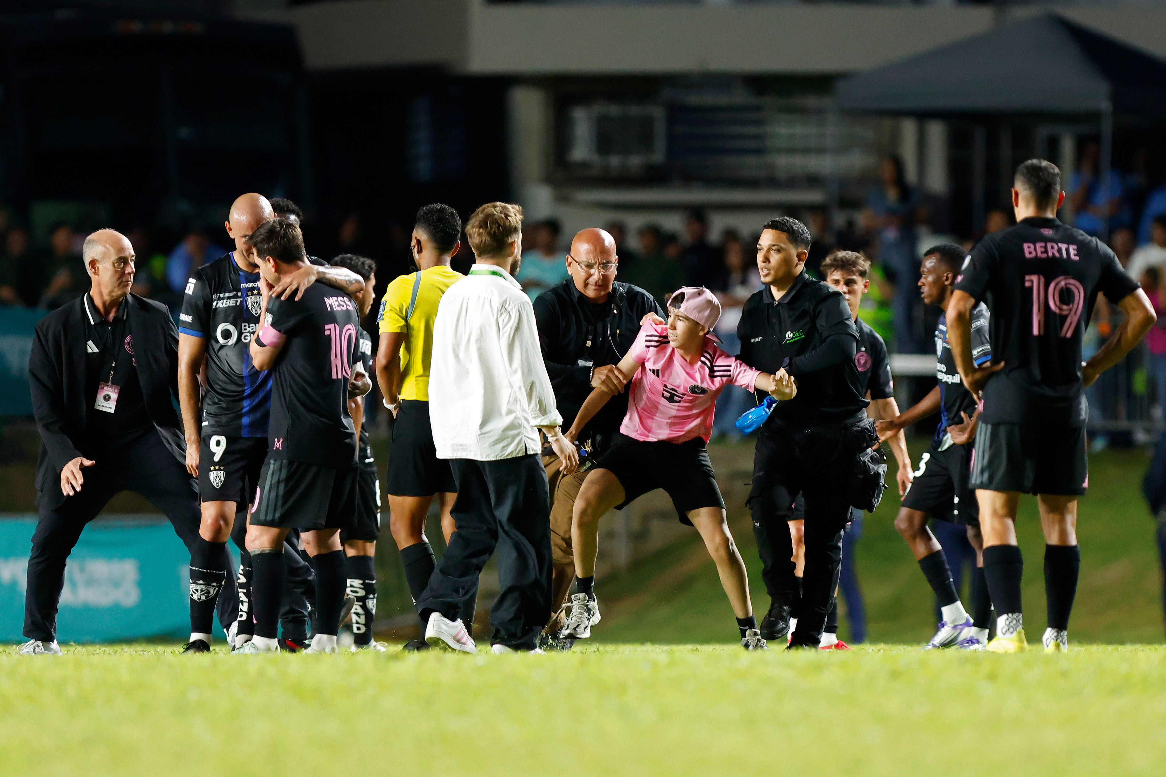 BAYAMON, PUERTO RICO - FEBRUARY 26: A kid is detained by security guards after jumping onto the field to greet Lionel Messi during a friendly game between Independiente del Valle and Inter Miami at Juan Ram&oacute;n Loubriel stadium on February 26, 2026 in Bayamon, Puerto Rico. (Photo by Leopoldo Smith/Getty Images)