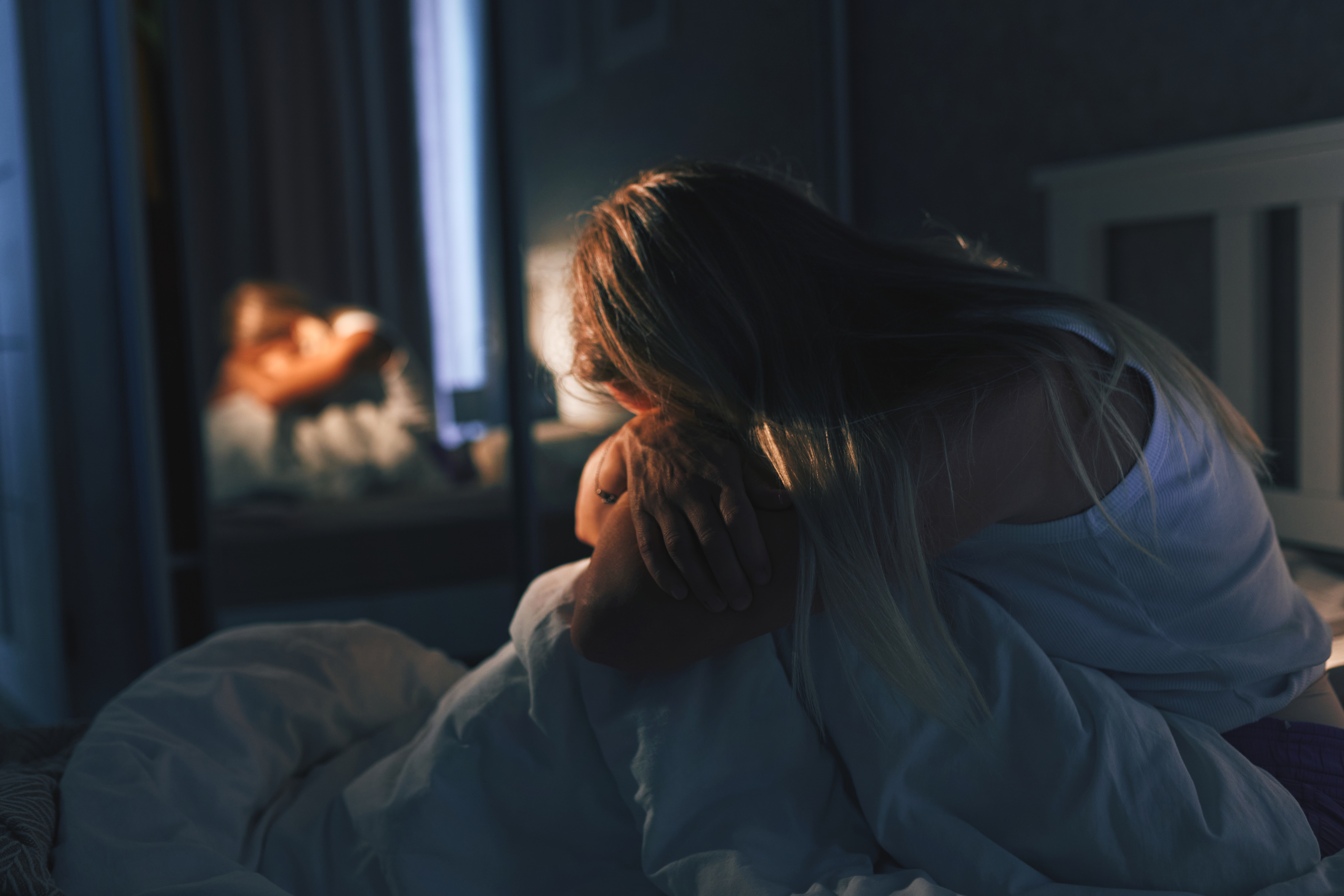 Lonely Woman in Dim Bedroom At Night, Reflective Behind-The-Scenes Moment